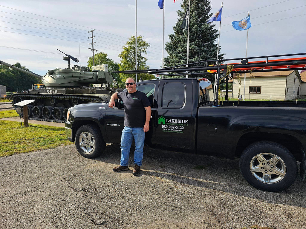 Dan of Lakeside Garage Doors & More in front od his work truck